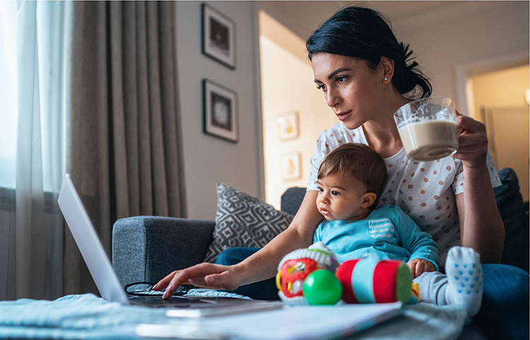 Lady and baby looking at bank statements on the computer.